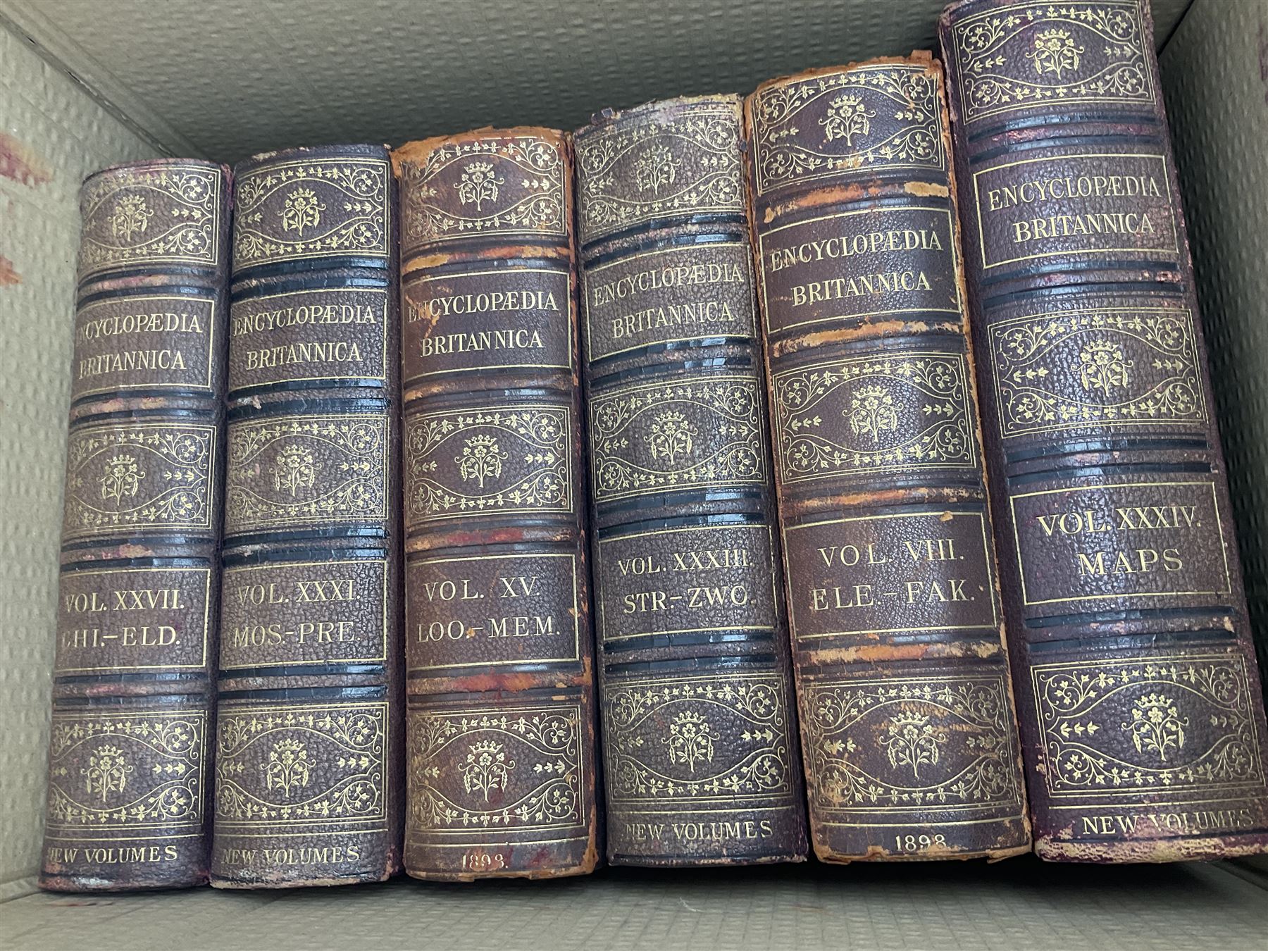 Thirty six volumes of Encyclopaedia Britannica with gold tooled red leather spines in various editions 