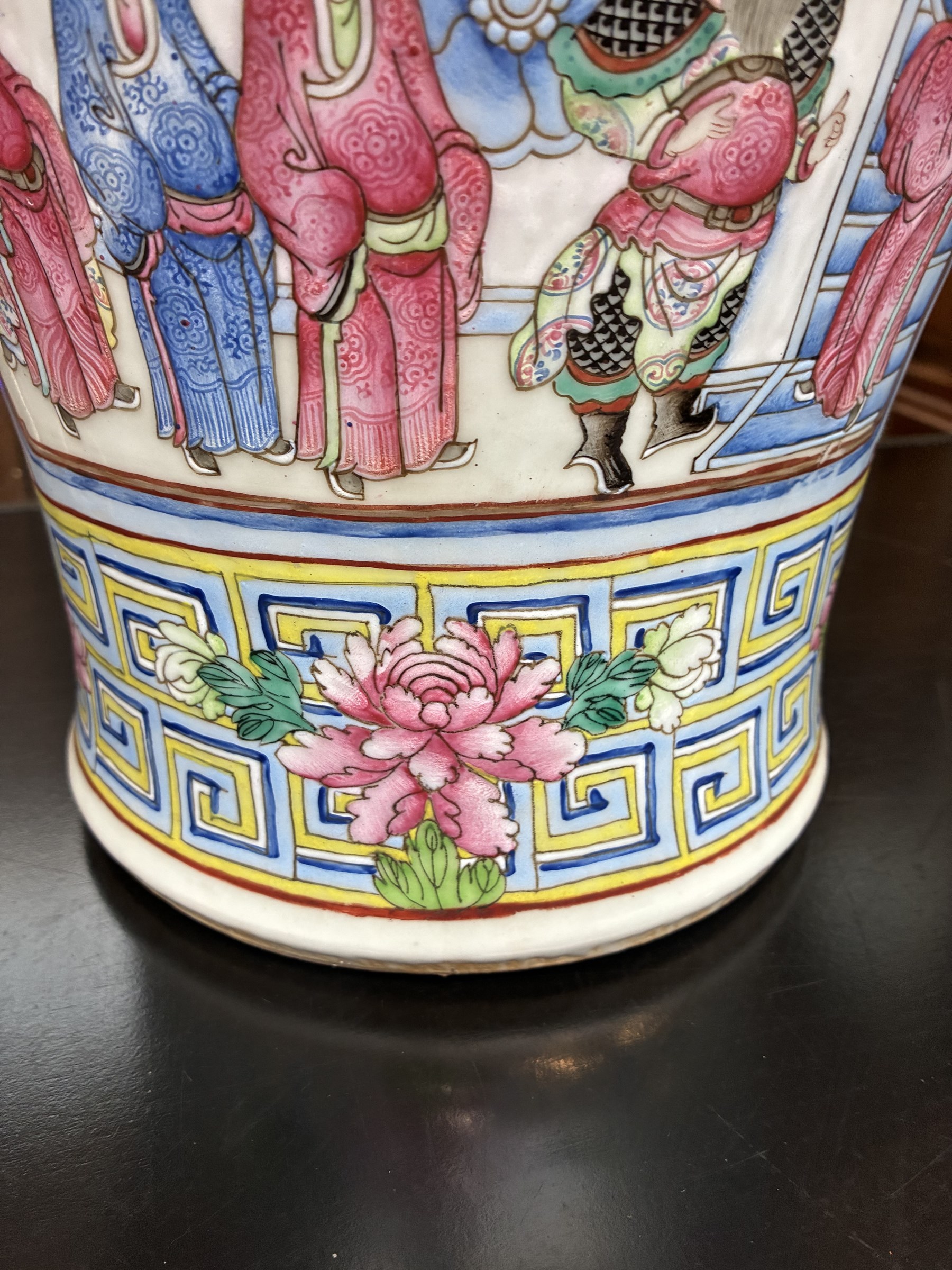 Large pair of 19th century Cantonese famille rose vases, each painted with various courtly scenes, including a display of warriors fighting on horseback before an official and his attendants, double Buddhist lion handles and applied at the shoulders with chilong, the lower band painted with Greek key motif, H58cm (2)
