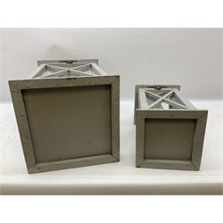 Two wooden lanterns with four glass sides, loop handles and open tops, largest example 58cm