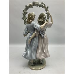 Lladro figure, Spring Dance, modelled as two girls beneath a flower arch, sculpted by Vincente Martinez, with original box, no 5069, year issued 1980, year retired 1981, H39cm