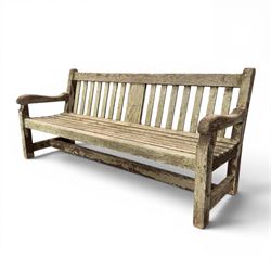 Teak garden bench with slatted back and seat raised on square supports