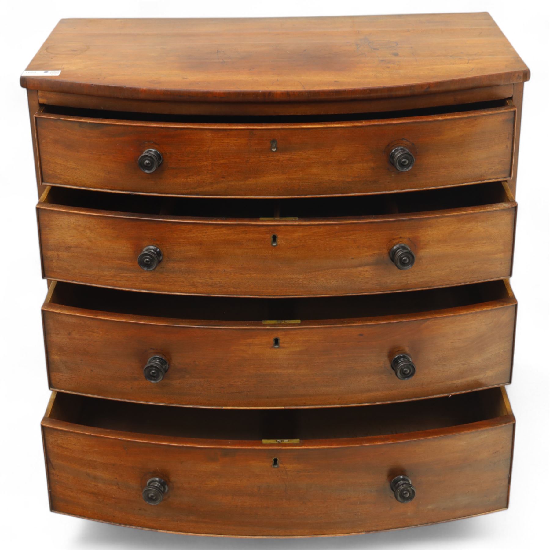 Mid-19th century mahogany bow front chest, fitted with four graduating drawers, turned ebonised handles, bun feet