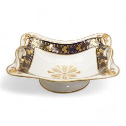 Large early 19th century Derby porcelain dessert basket, of rectangular twin-handled form, with cobalt blue and gilt decoration, painted marks beneath, L29cm together with a 19th century porcelain dessert service, decorated with floral sprays within a green and gilt border, comprising eight plates and three serving dishes, pattern no. 701/1