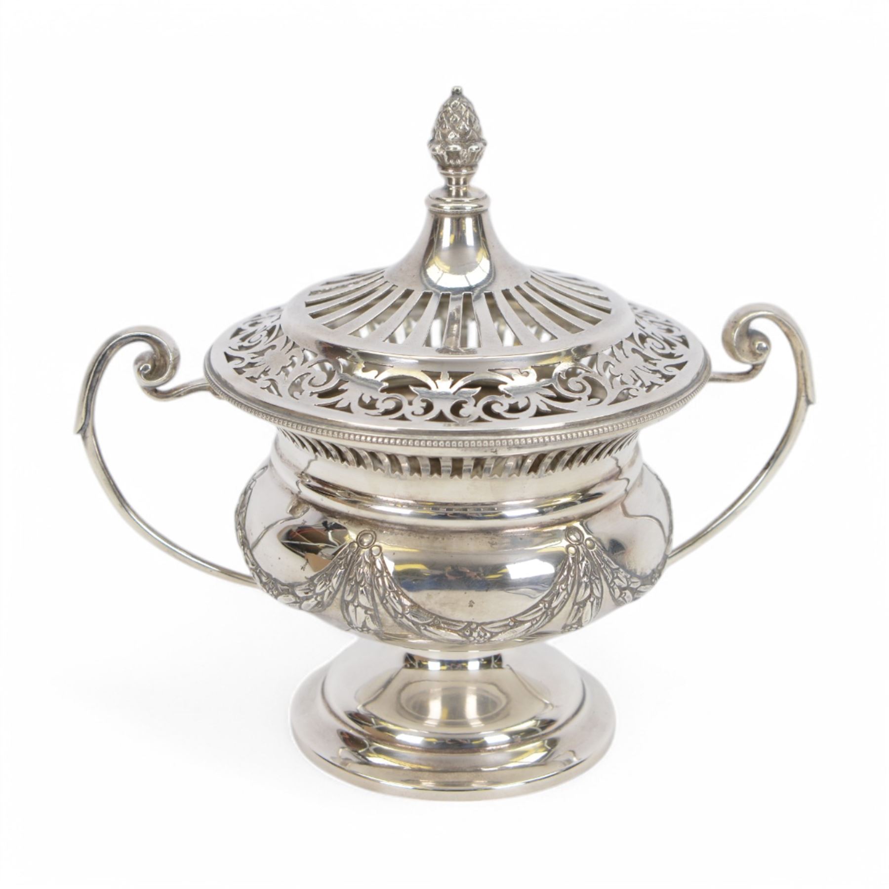 Early 20th century silver twin handled lidded bowl, of circular form with C scroll handles, the body embossed with floral swags, the pierced lid with pineapple finial, hallmarked Horace Woodward & Co Ltd, London 1911, H16cm
