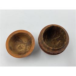 Three 19th century coquilla nut pomanders or flea catchers, two of egg shaped form and the third of barrel from with carved and pierced decoration and screw threaded join, largest H8cm