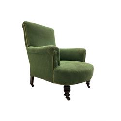 Victorian armchair, upholstered in foliate patterned laurel green fabric, raised on ring turned supports with castors