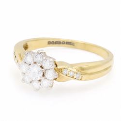 18ct gold diamond flower head cluster ring, set with nine round brilliant cut diamonds, with diamond set shoulders, London 1991, total diamond weight approx 0.40 carat