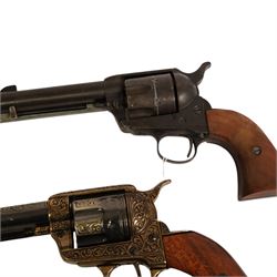 Two replica colts, each with a leather holster 