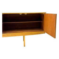 Mid-20th century teak sideboard, fitted with a fall-front cupboard, three drawers including a green baize-lined cutlery drawer, and a double cupboard, with integrated handles, on sleigh supports