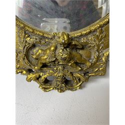 Composite ornate oval gilded wall mirror, decorated with putti and a foliate border, with oval bevelled mirror plate, H53cm