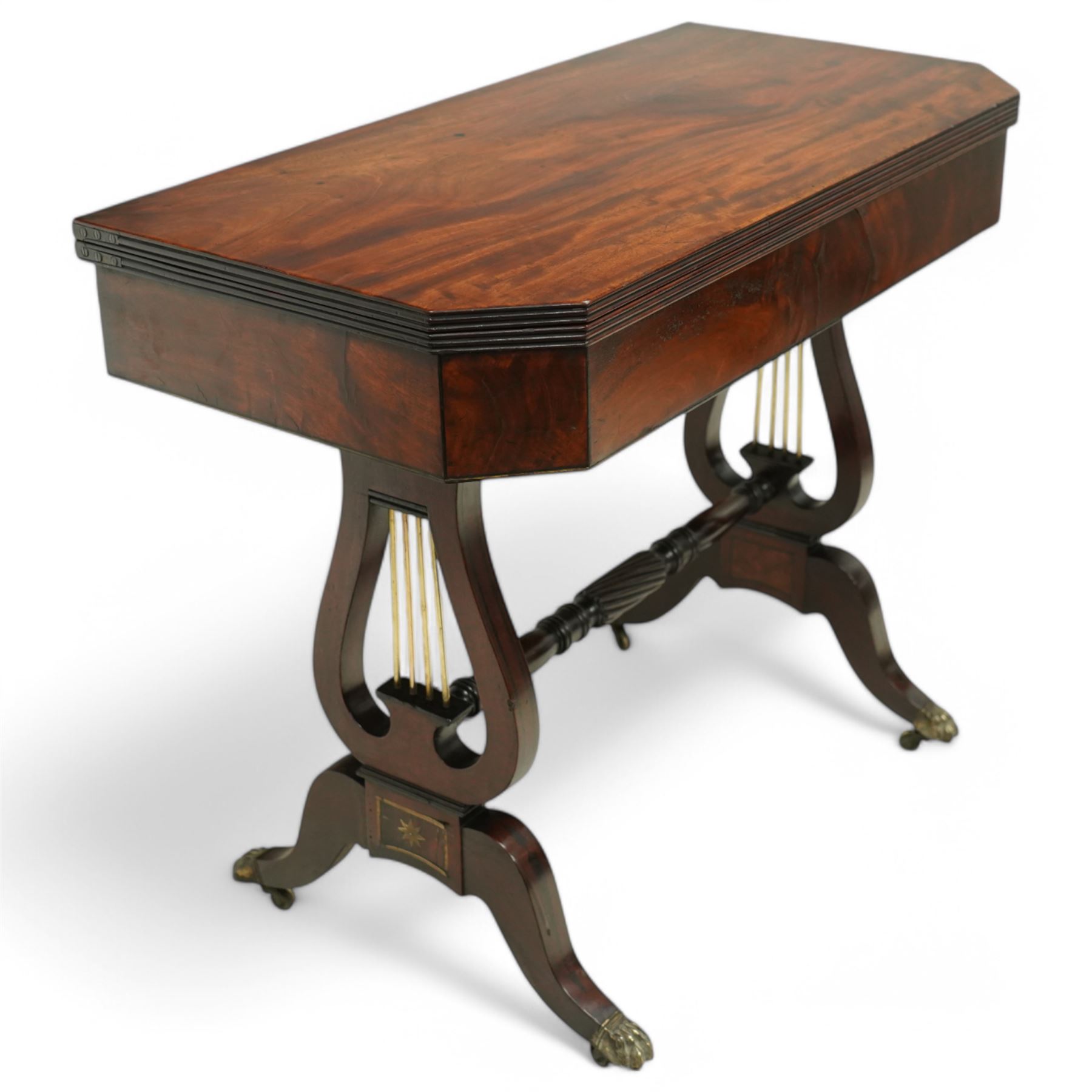 Regency mahogany and ebony inlaid fold-over tea table with reeded edge above spiral reeded centre stretcher on lyre supports with brass star inlaid panel on out swept legs with lion paw brass castors 