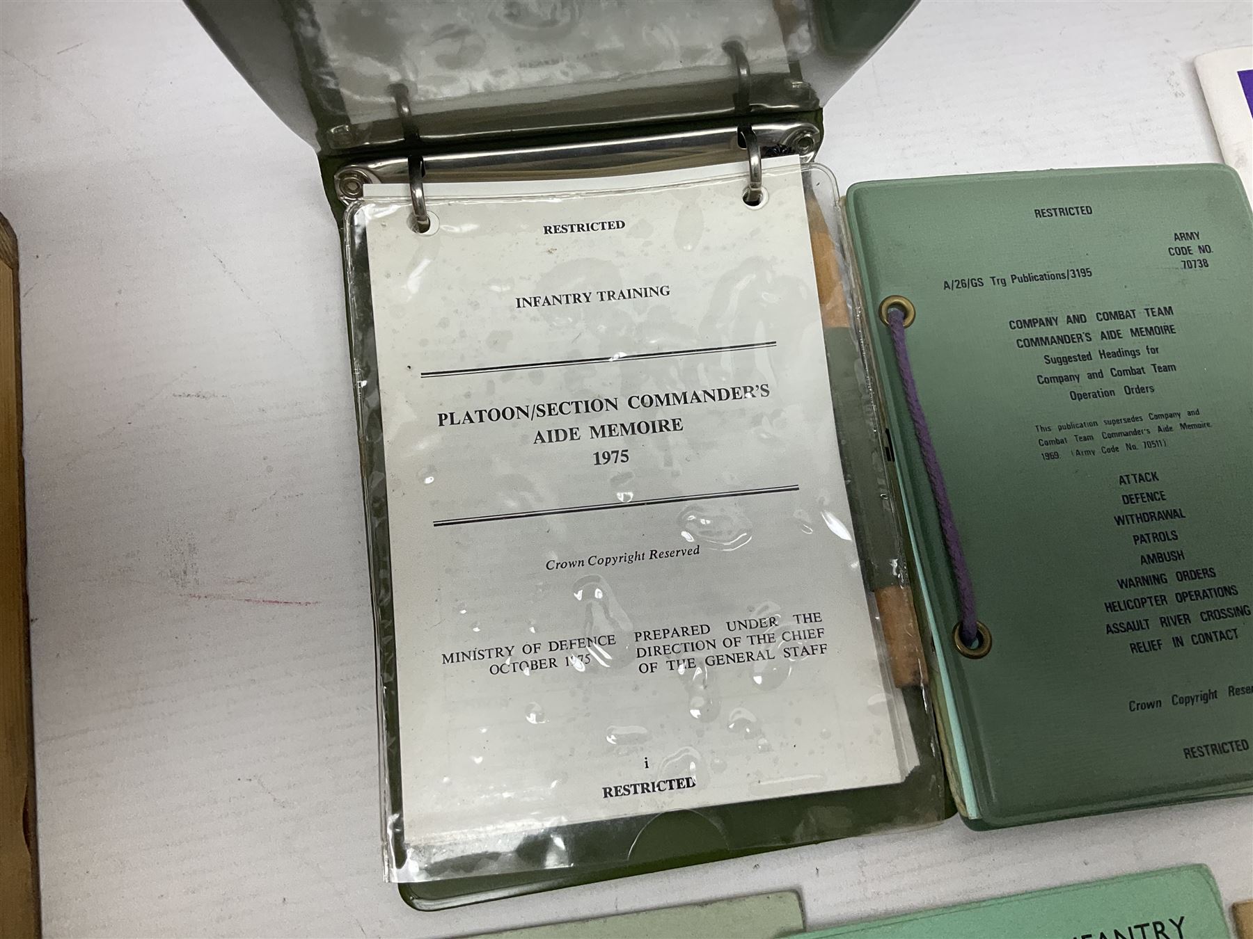 Collection of nineteen British Army booklets 1940s - 1970s including Small Arms Training 1944, various Infantry Training, Cadet Training Manual 1978, Signal Training, Commander's Aide Memoires etc; 1950s blue beret with Yorks Brigade badge; part travelling toilet set in cloth roll; all contained in pine box with webbing straps