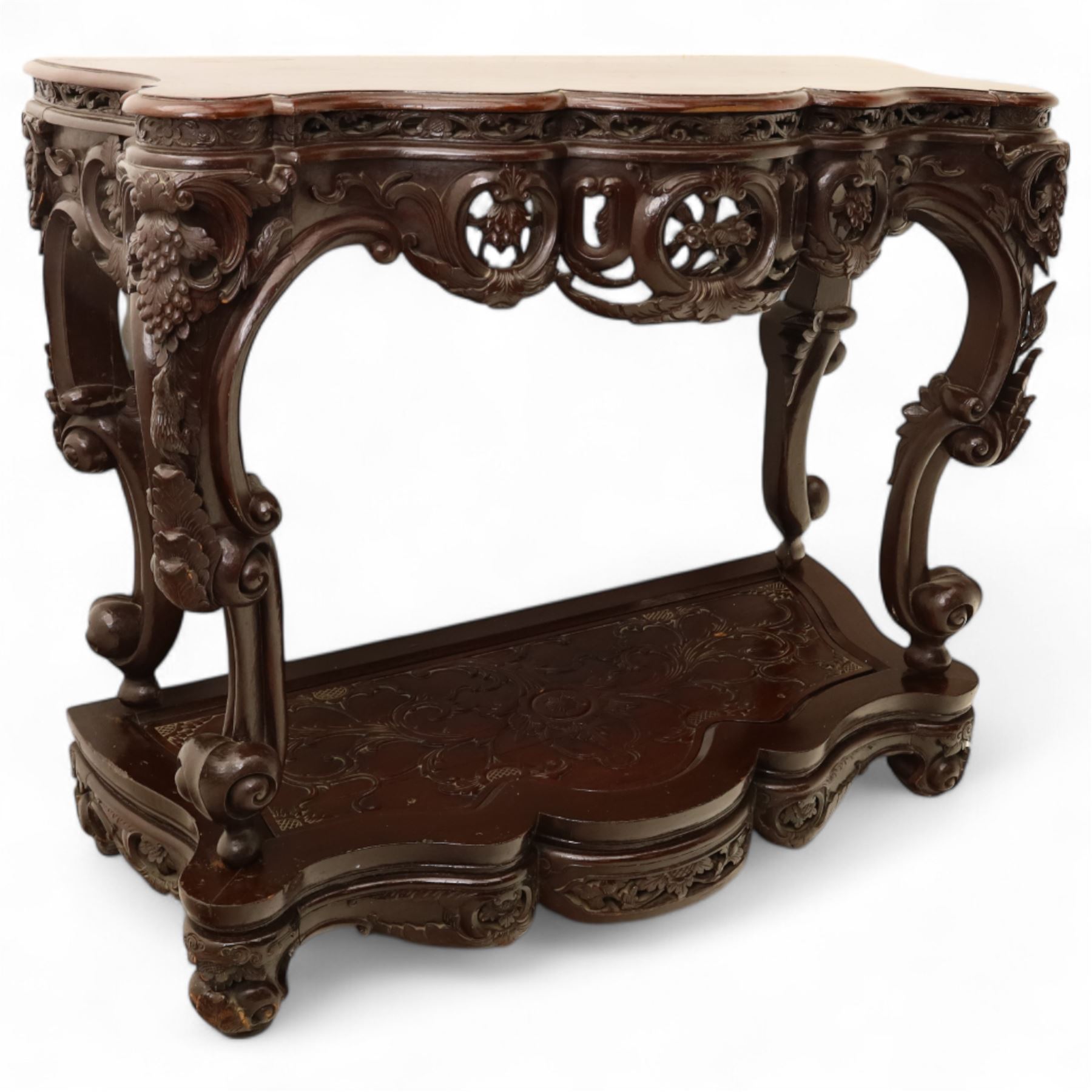 Chinese stained hardwood side table, late Qing dynasty style, with shaped top above a pierced and carved frieze of foliage and fruiting vines, cabriole legs terminating in scroll feet, united by a carved shaped undertier