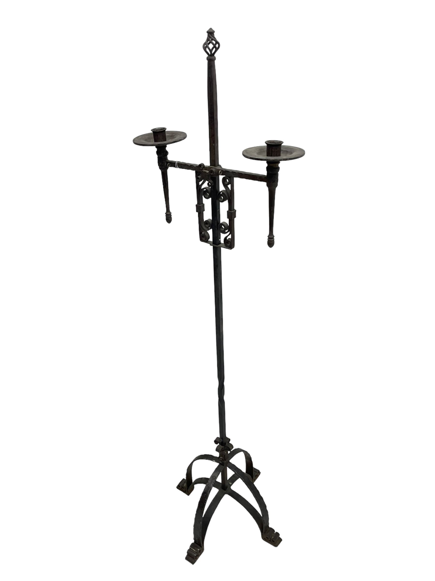 Ironwork candle holder stand, with stamped decoration, adjustable two branch sconces with scrolled iron work, twist stem with arched supports with scrolled terminals
