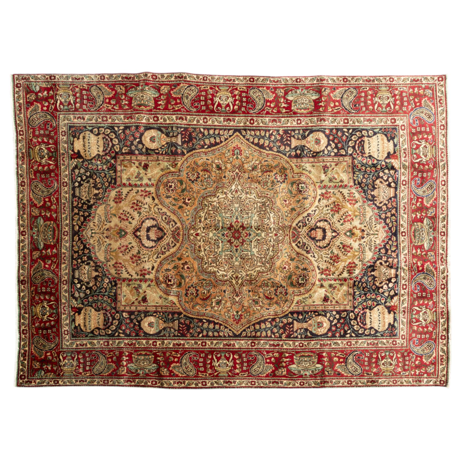 Azerbaijan rug, intricate central medallion in muted golds and greens surrounded by navy panels filled with boteh and floral designs, enclosed by a red main border featuring stylised boteh motifs, woven in the Caucasus region of Azerbaijan