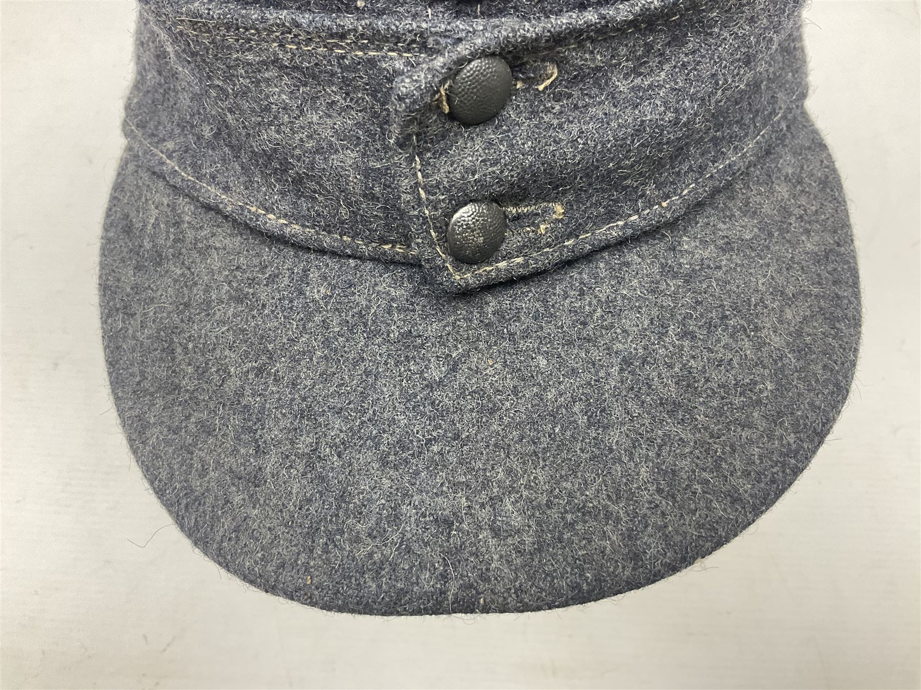 WW2 German Luftwaffe M43 field cap with triangular cloth eagle and roundel badge; marked '1944 ?/0501/0015 57'