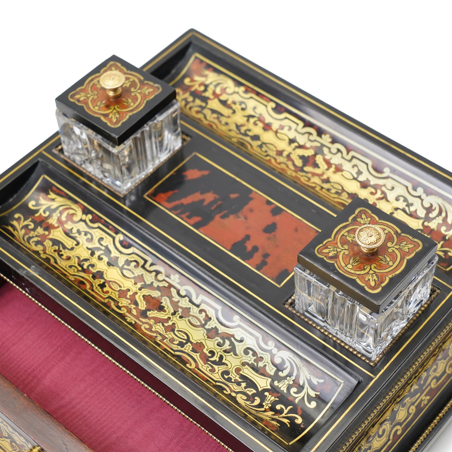 Mid 19th century Boulle inkstand in cut brass and tortoiseshell with beaded decoration with two pen trays and two inkwells on a single drawer base and compressed bun feet W32cm 