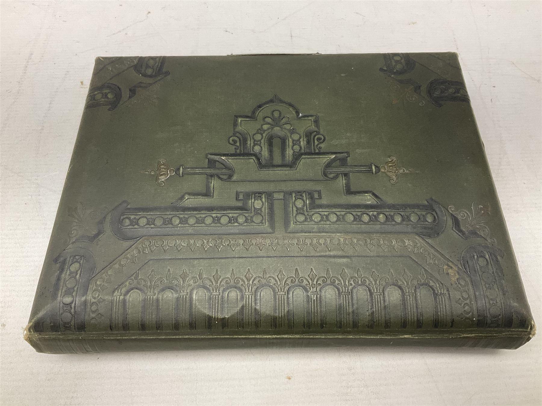 Victorian desk ink blotter, decorated with painted spray of flowers within stylised gilt rococo spandrels with mother of pearl fixings, together with a Victorian photo album containing interior leaves with apertures of various sizes and shapes of portraits surrounded by printed sea and dock scenes, blotter L28cm
