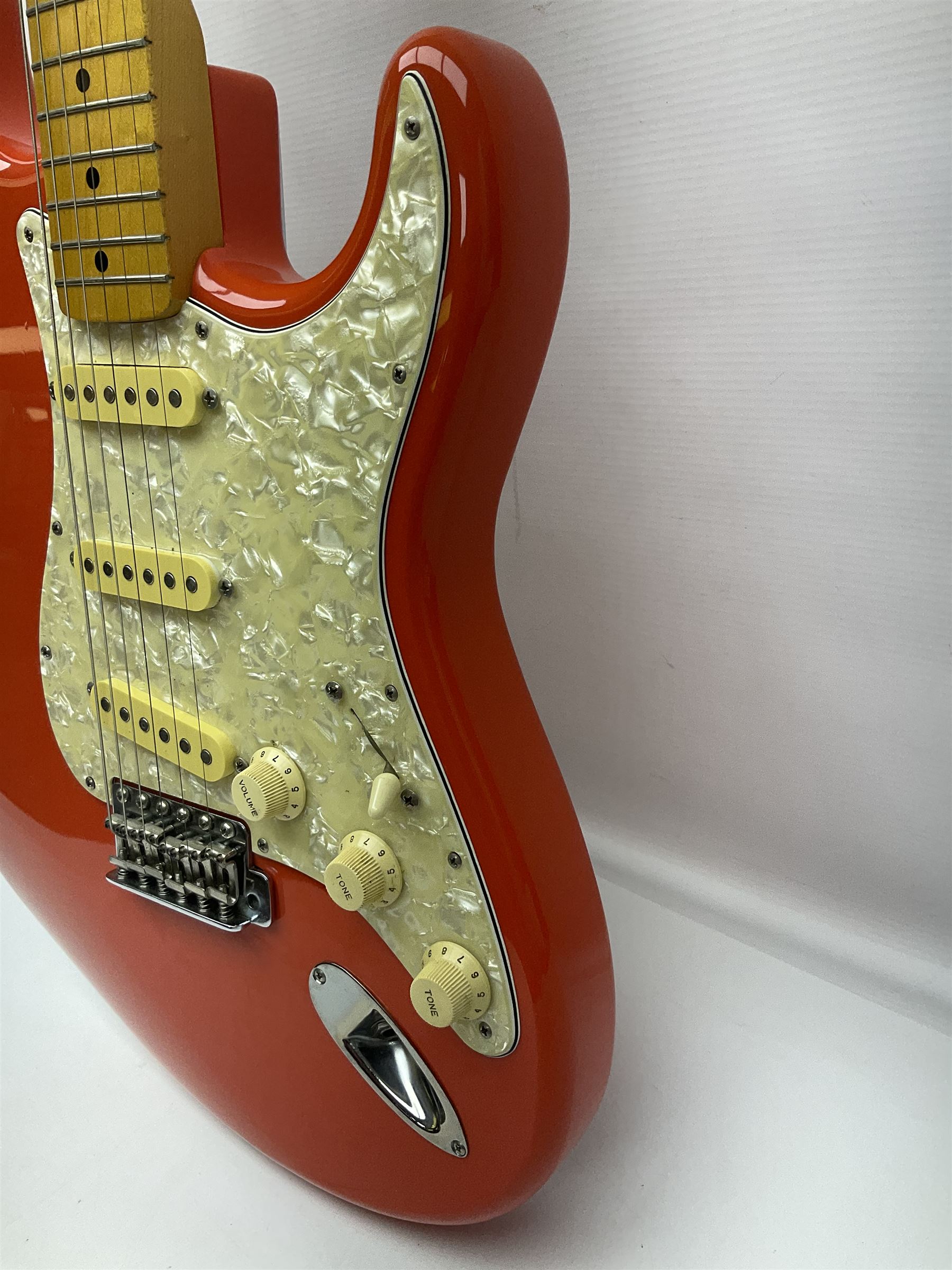 Japanese Squier Fender 'Hank Marvin' Stratocaster electric guitar, c1992, in Fiesta red with tremolo arm and facsimile signature decal; serial no.L037281, L98cm; in hard carrying case.