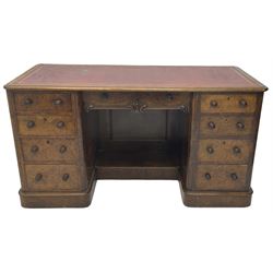 Victorian figured walnut kneehole desk, moulded rectangular top with inset leather writing surface, fitted with nine drawers, the central frieze drawer with carved curled foliage mount, on moulded plinth base,