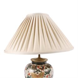 Japanese ceramics table lamp, decorated with flowers and butterflies upon a circular wooden base, H52cm