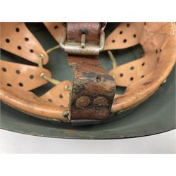 1960s Italian parachutist helmet with liner; camouflage paintwork with parachutist crest to the front