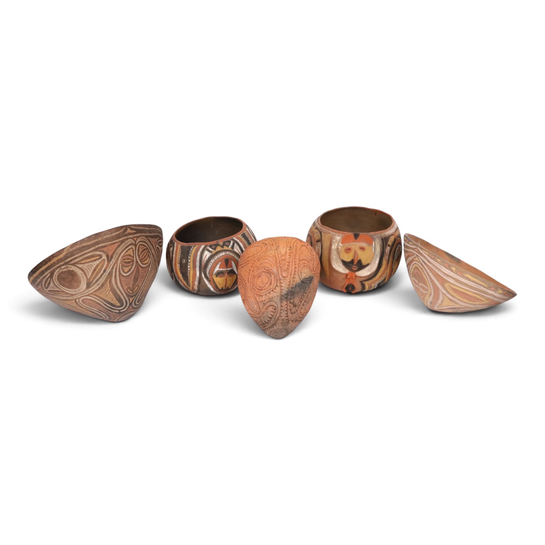 Two terracotta clay cooking pot, decorated with faces in neutral tones, together with three similar pots