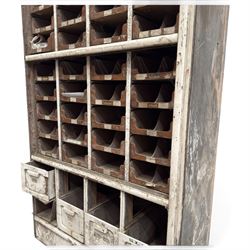 F Pollard & Co - late 19th century rustic haberdashery shop cabinet, fitted with an assortment of forty sliding trays, with drawers fitted to base, in antique white-painted finish