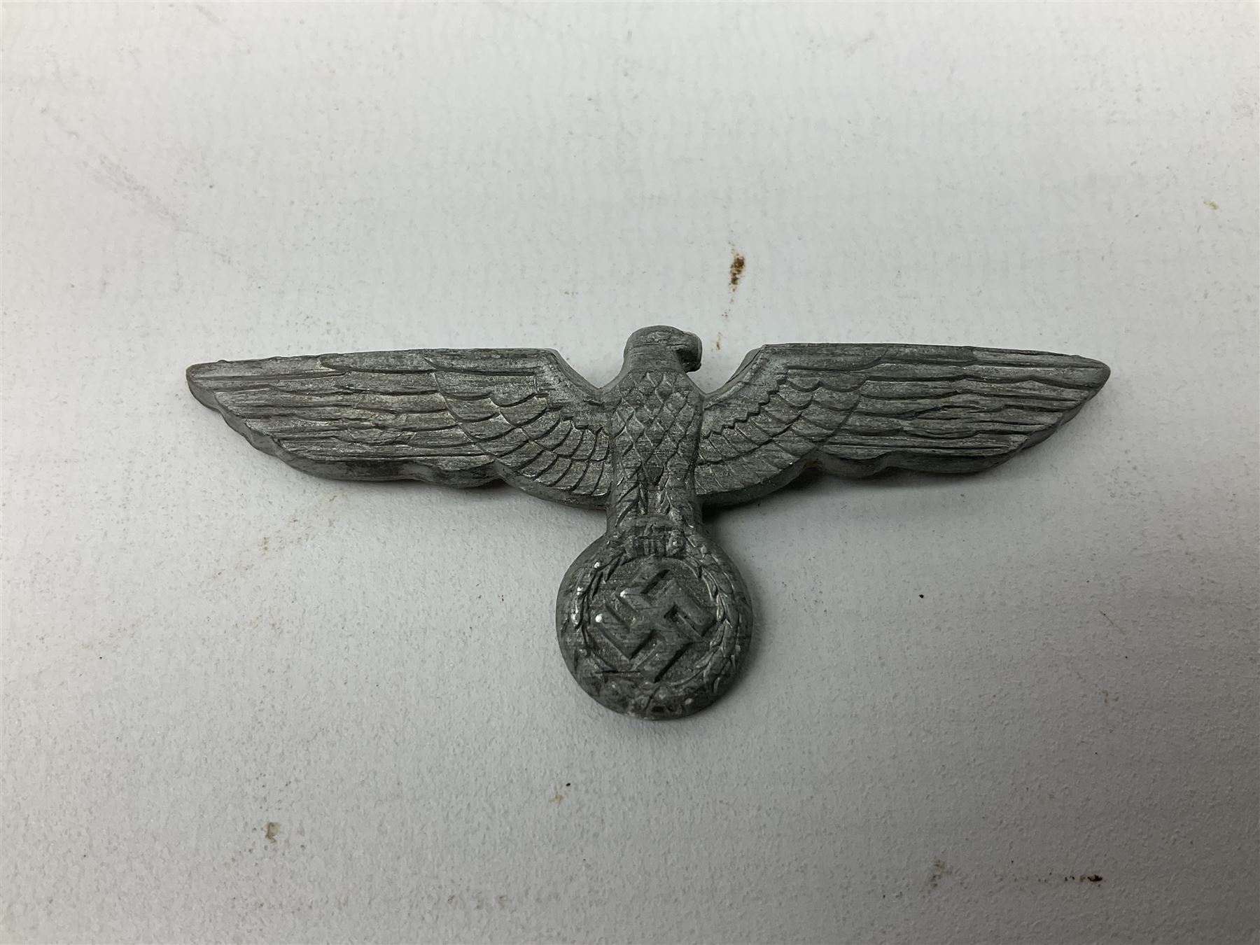 Five WW2 German peaked cap badges, four with double-pinned backs