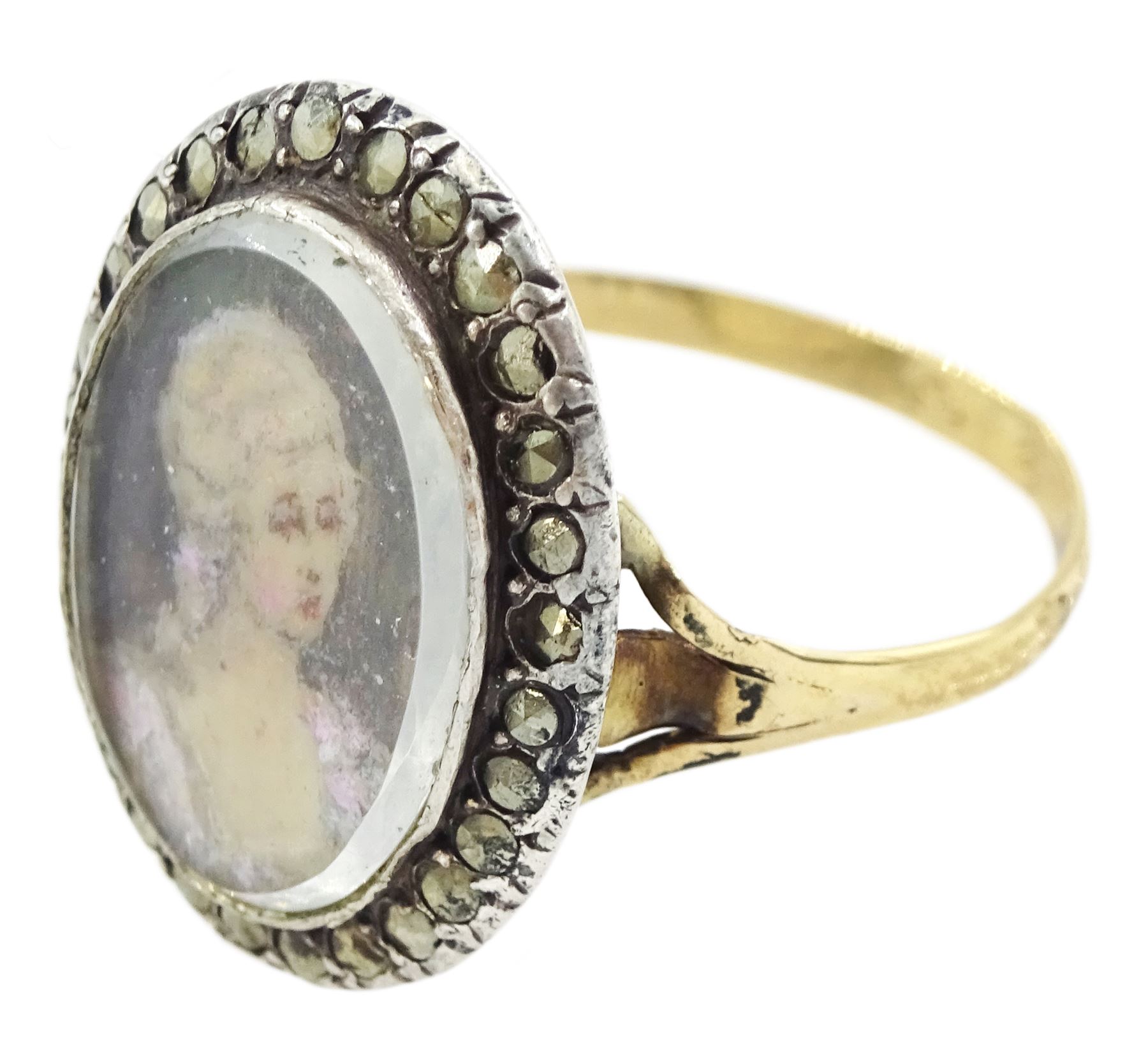 19th century French 18ct gold and silver marcasite portrait ring, set with an oval miniature of a woman on ivory, under glazed panel, with marcasite surround and trifurcated shoulders, hallmarked. This lot has been registered for sale under Section 10 of the APHA Ivory Act