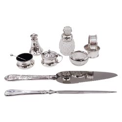 Group of silver, to include a three piece cruet set, comprising pepper shaker, open salt and mustard pot with cover, hallmarked James Walter Tiptaft, Birmingham 1932, together with two napkin rings, silver mounted glass bottle and salt, silver handled pie server and a silver letter opener and a letter opener, all hallmarked 