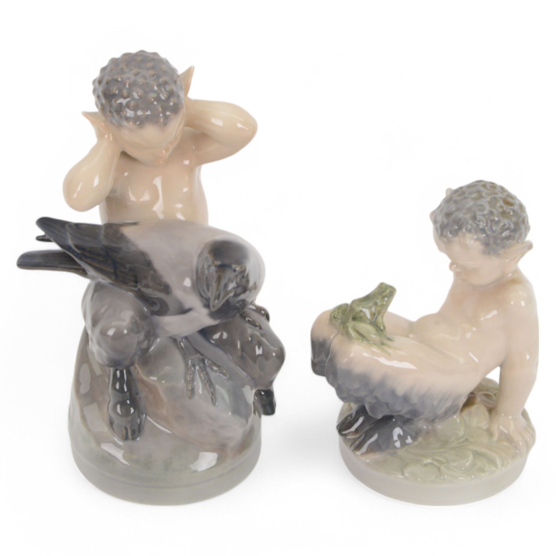 Three Royal Copenhagen figures, comprising Faun and Frog no. 1713,  Fawn and Owl no. 2107 and Faun with a Raven no.2113