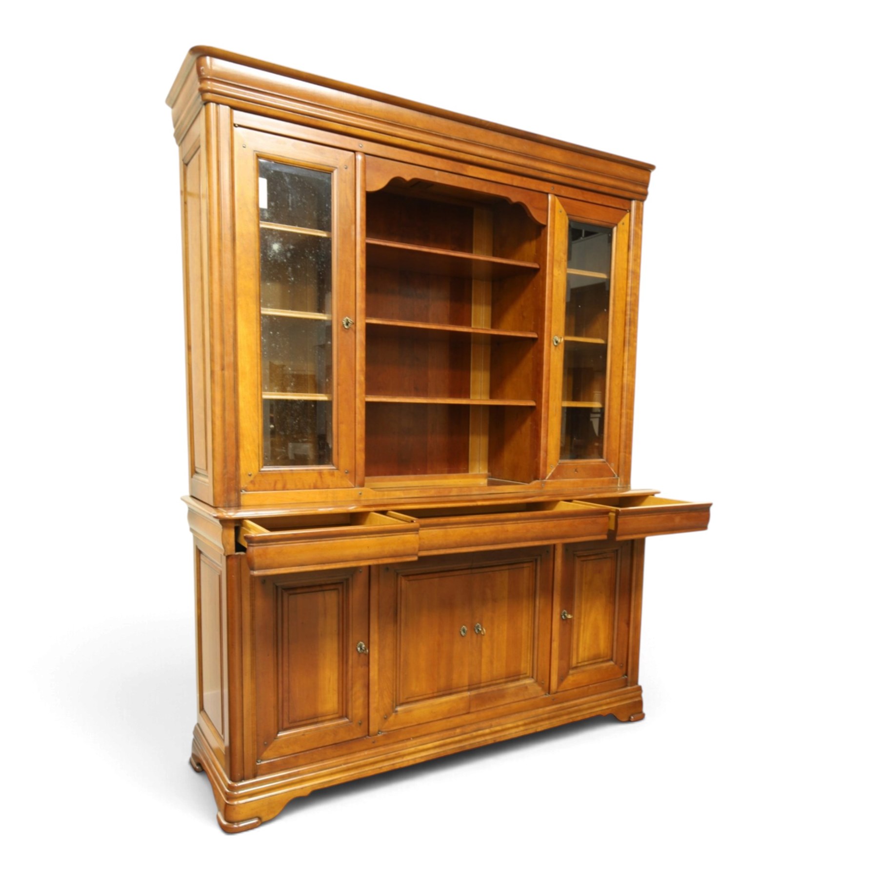 Barker & Stonehouse - large cherrywood bookcase cabinet, the moulded cornice above two glazed doors flanking an open central section, the base with three cushion drawers over four lockable panelled cupboard doors, raised on bracket feet