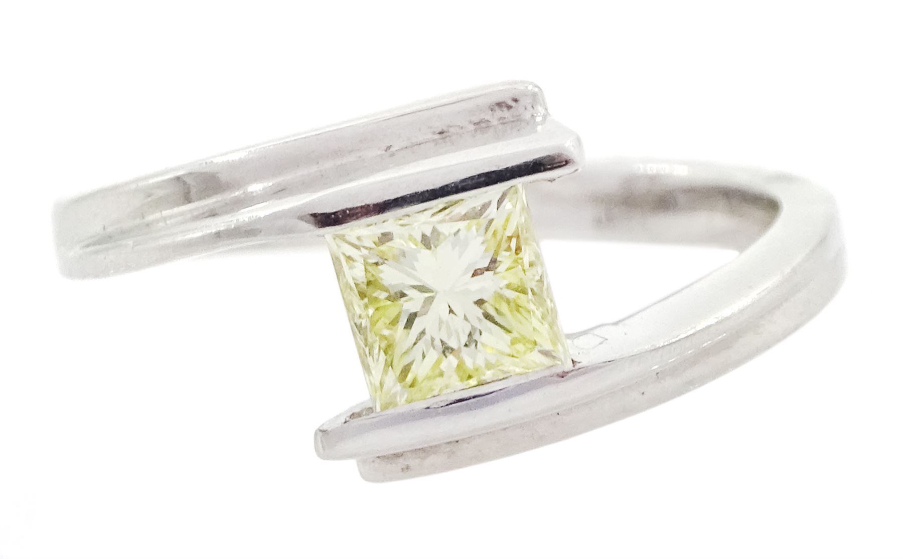 Platinum diamond ring, tension set with a single princess cut fancy yellow diamond of approx 0.60 carat, hallmarked