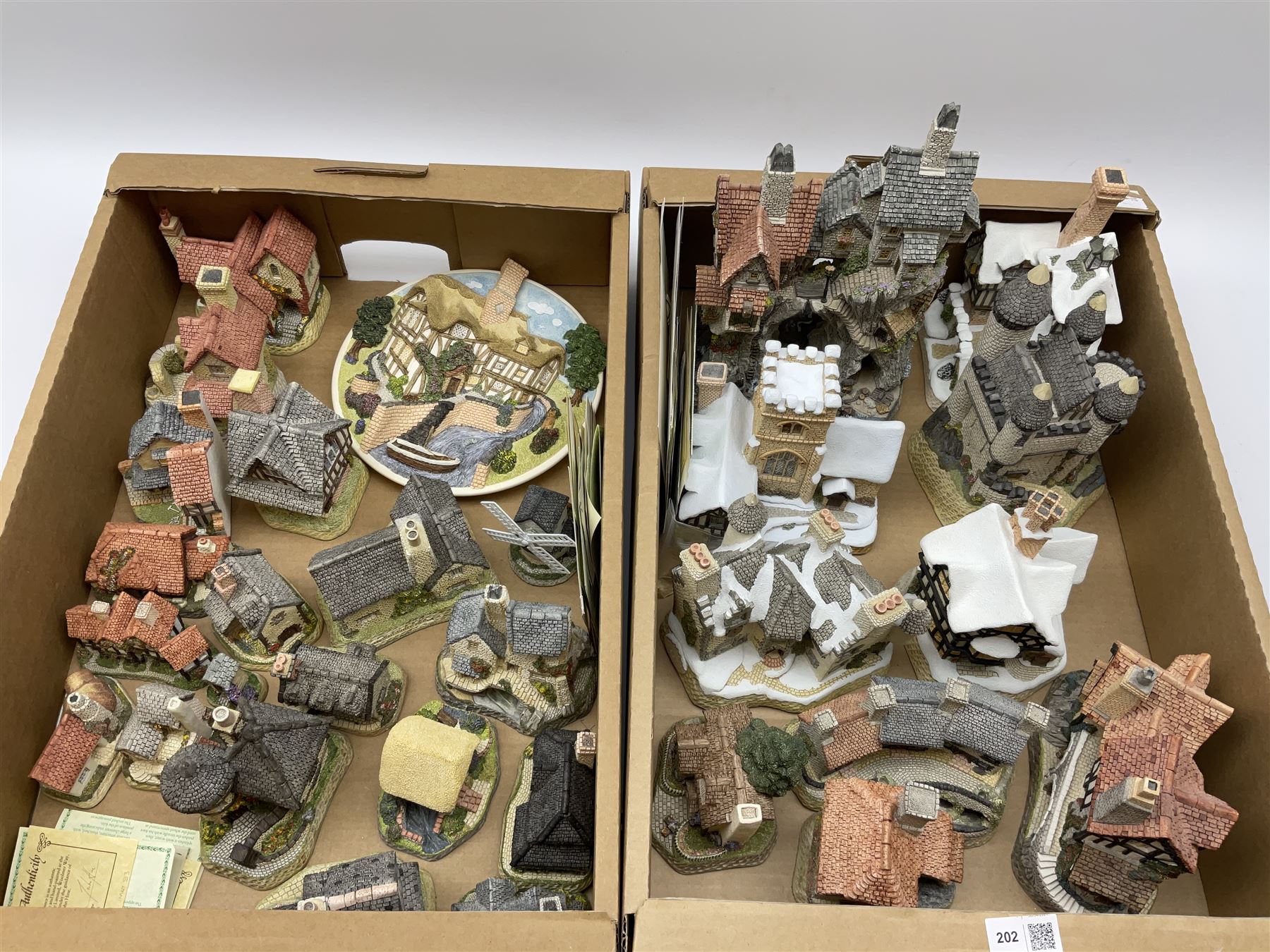 A collection of boxed David Winter cottages, of various size and form, to include Wreckers Cottage, Scottish Collection Macbeth's Castle, Special for Christmas 1988 Christmas in Scotland and Hogmanay, Special for Christmas 1990 Mister Fezziwig's Emporium, The Scrooge Family Home, Special for Christmas 1989 A Christmas Carol, The Midlands Collection Miners Row, Will-o-the wisp, etc., together with a plaque titled On the Riverbank, a number of examples with accompanying certificates. (30).