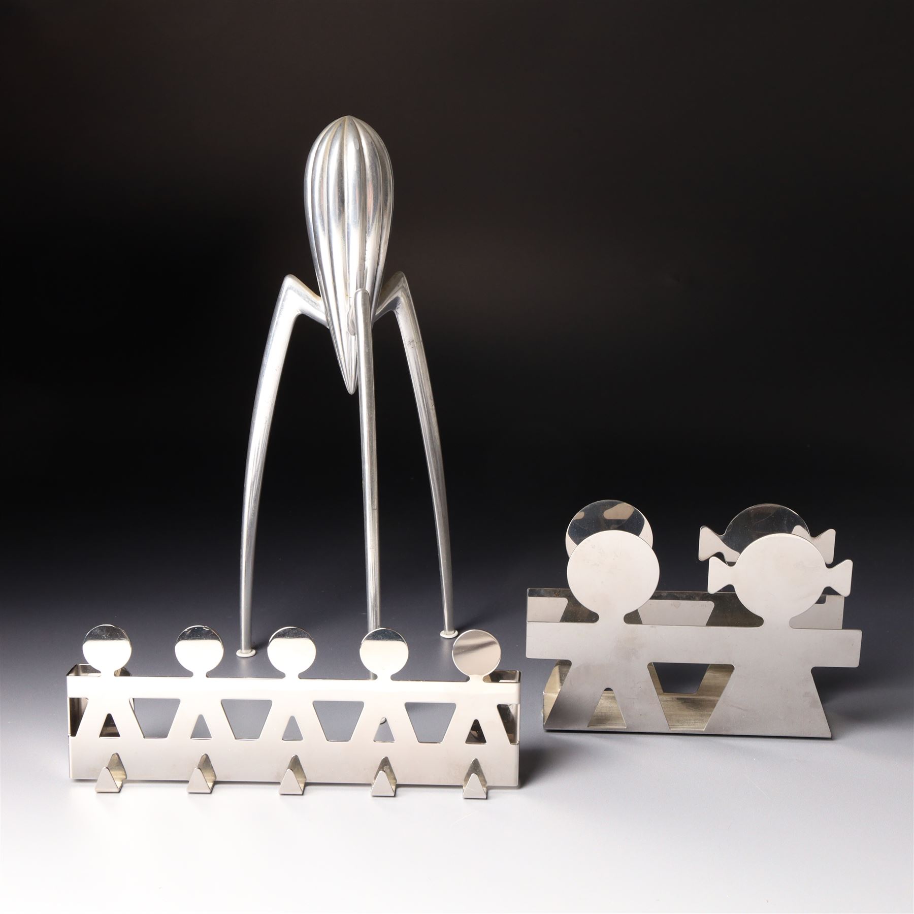Collection of Alessi items, comprising a 'Juicy Salif' lemon squeezer designed by Philippe Starck, a condiment set designed by Ettore Sottsass, two 'Carlo - a ghost on top of a bottle' designed by Mattia Di Rosa, and further items, all stamped (10)
