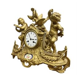 French - late 19th century 8-day  spelter mantle clock depicting two dancing children and a pair of nesting doves, white enamel dial with Roman numerals and steel moon hands, countwheel striking movement striking the hours and half-hours on a bell. With pendulum. 