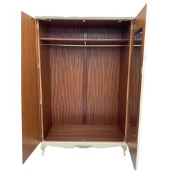 French classic design cream painted double wardrobe, the doors decorated with gilt and cream applied urn motifs with extending bell-flower festoons and ribbon twists, enclosing shelf and hanging rail, shaped apron on acanthus cabriole feet