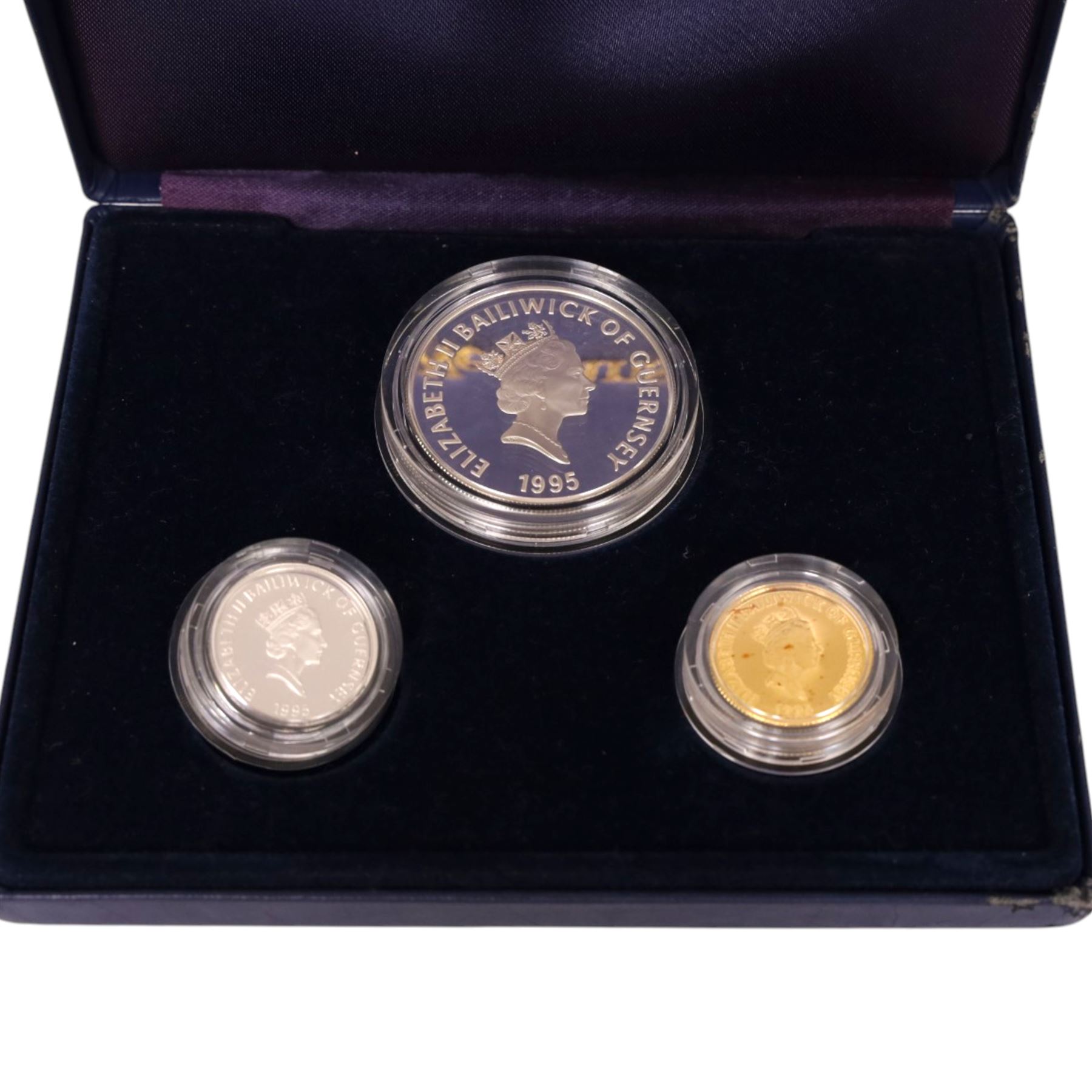 The Royal Mint Guernsey 1995 'Queen Elizabeth The Queen Mother 95th Birthday Family Set', comprising gold proof twenty five pound coin, silver proof five pound, and silver proof one pound, cased with certificate