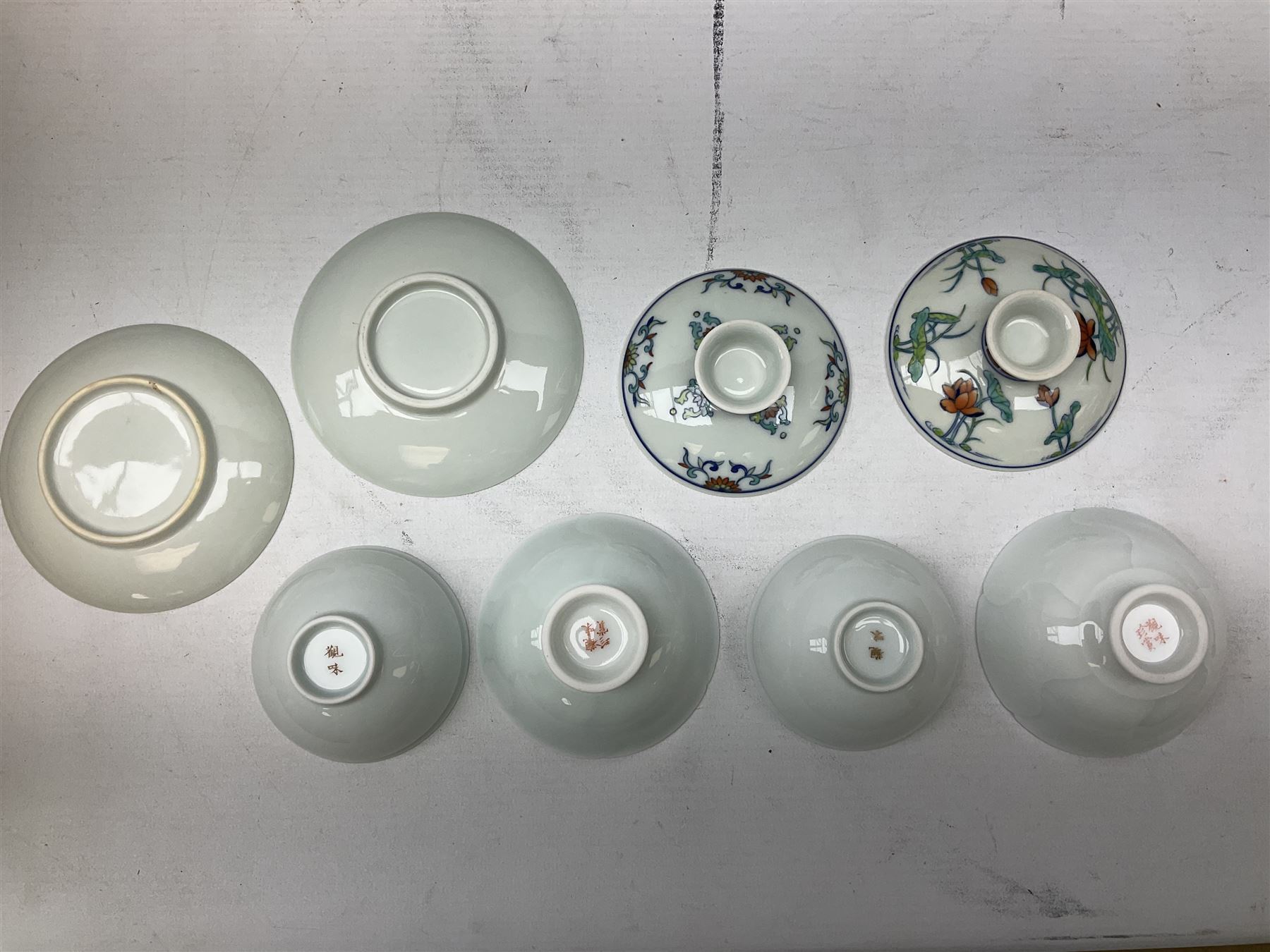 Two Chinese Yixing teapots, Chinese tea bowl hand painted with figures reading, another tea bowl with with underglaze floral panel and another tea bowl with saucer and lid, together with other teacups etc all boxed and with character marks