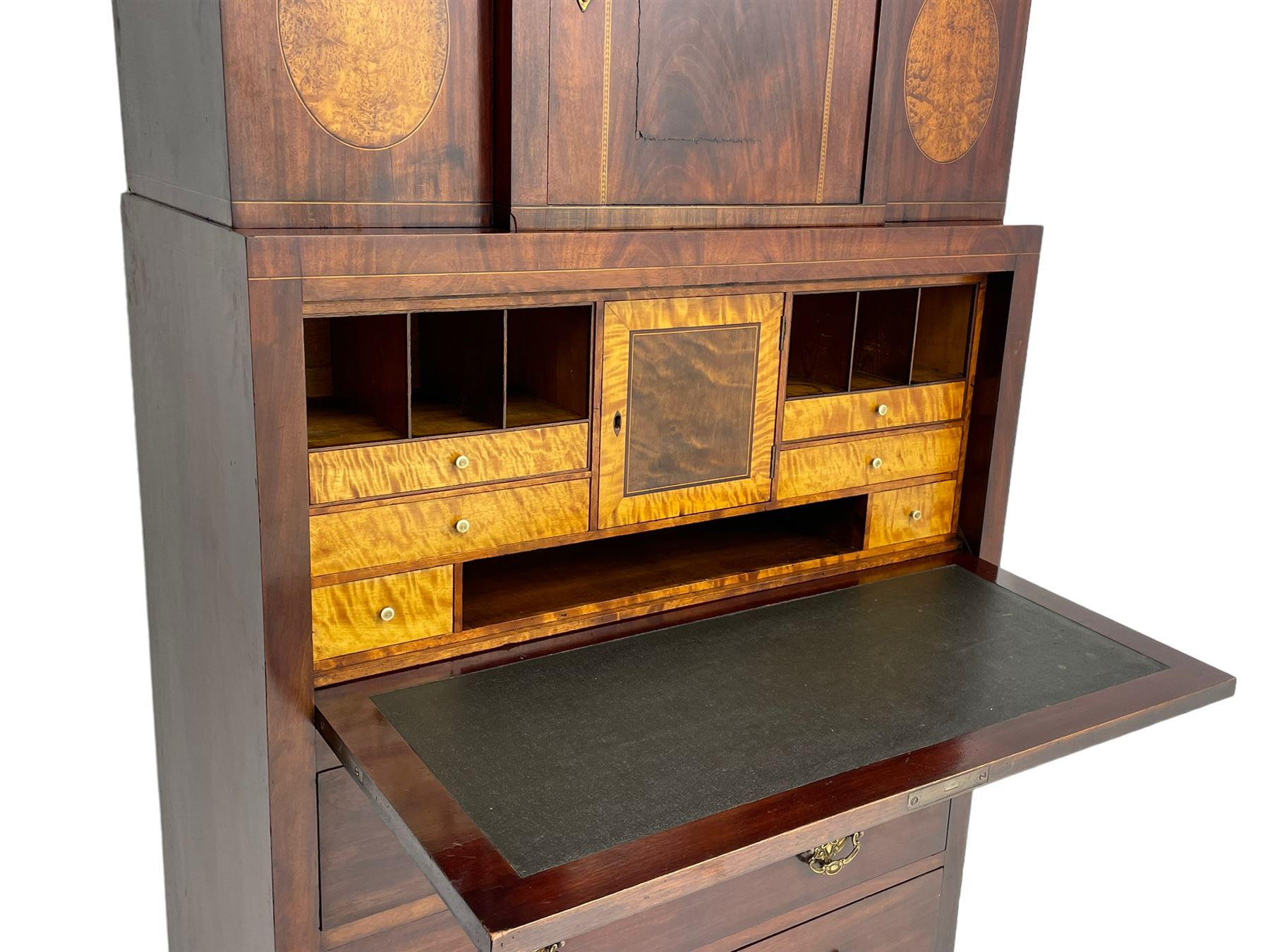 Early to mid-19th century figured mahogany Continental secrétaire à abattant, stepped top fitted with single cupboard, inlaid with oval figured amboyna panels, the fall front inlaid with shell motif enclosing a satinwood interior fitted with cupboard, drawers, and pigeon holes, three long drawers below, on square tapering feet