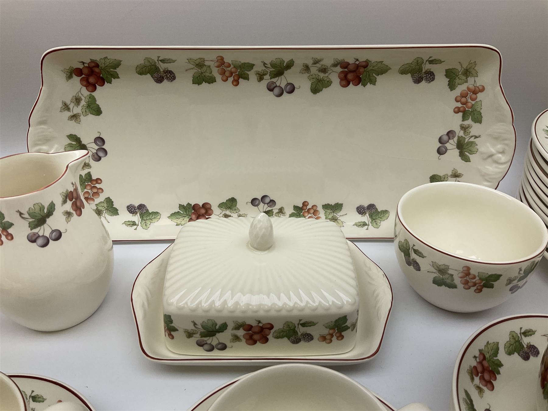 Wedgwood Queens Ware tea and dinner wares in Provence pattern, including ten cups and saucers, milk jug, butter dish with cover, ten dinner plates, ten bowls and ten side plates etc (71), together with Royal Doulton tea wares in Canton pattern, comprising six cups and saucers, milk jug, open sucrier and six dessert plates.    