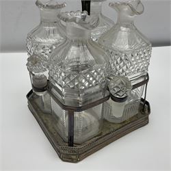 19th century Sheffield silver plated decanter stand, the square base with pierced gallery housing four cut glass decanters and stoppers, with central carrying handle, H27cm