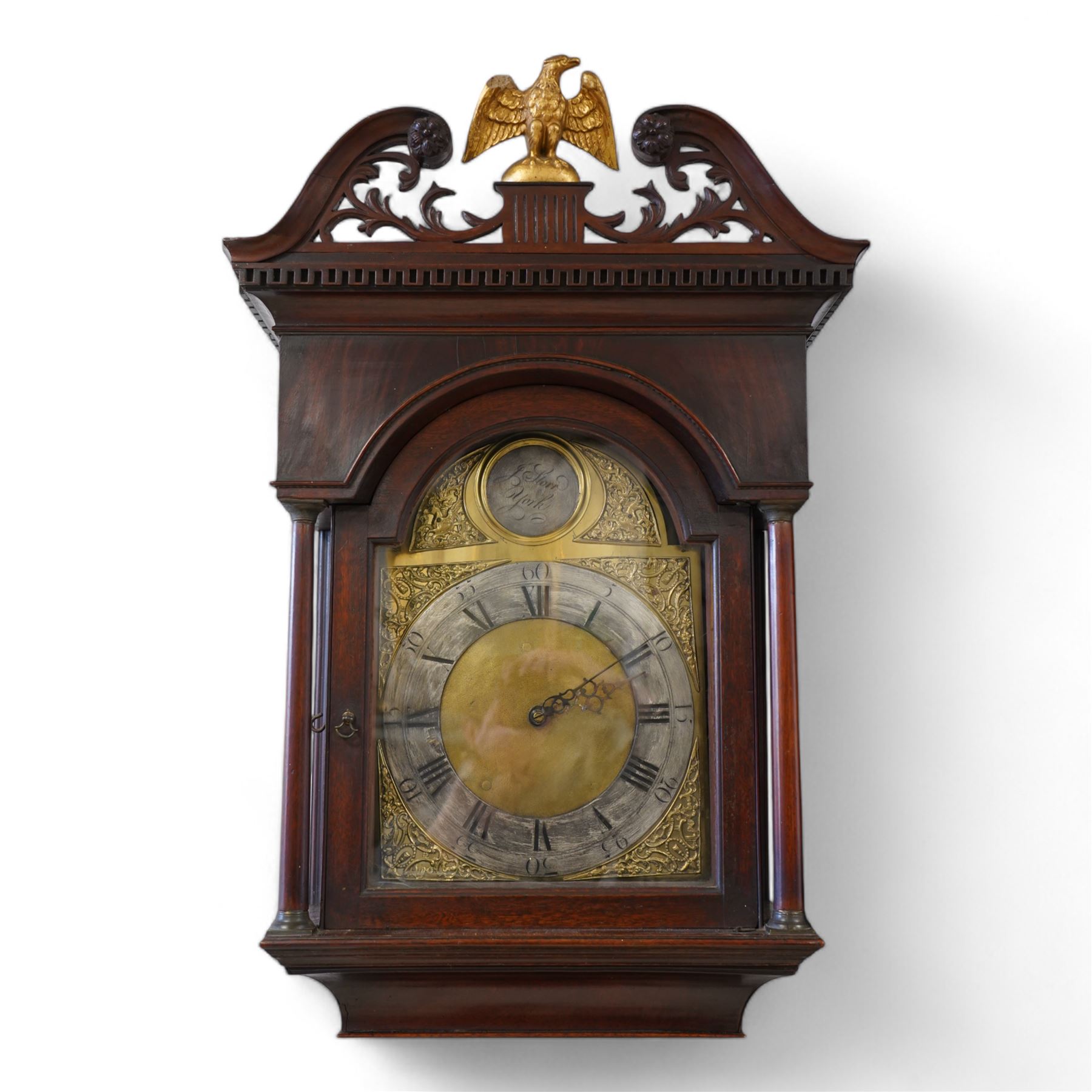 Johnathan Storr of York - 30 hour longcase clock c1770, in a later mahogany case with a decorative swan neck pediment, carved gilded eagle and fretwork, with a dogtooth moulding, break arch hood door and detached pilasters beneath, trunk with a conforming break arch topped door on a square plinth with raised moulding and bracket feet, brass arched dial with makers name to the arch, plain dial centre and silvered chapter ring with Roman numerals, five minute Arabic's, minute track and matching steel hands, chain driven movement with a countwheel strike on a bell. No Pendulum or weight.
Johnathan Storr was an 18th century York clockmaker, working from Petergate and Minster gates in the city centre.