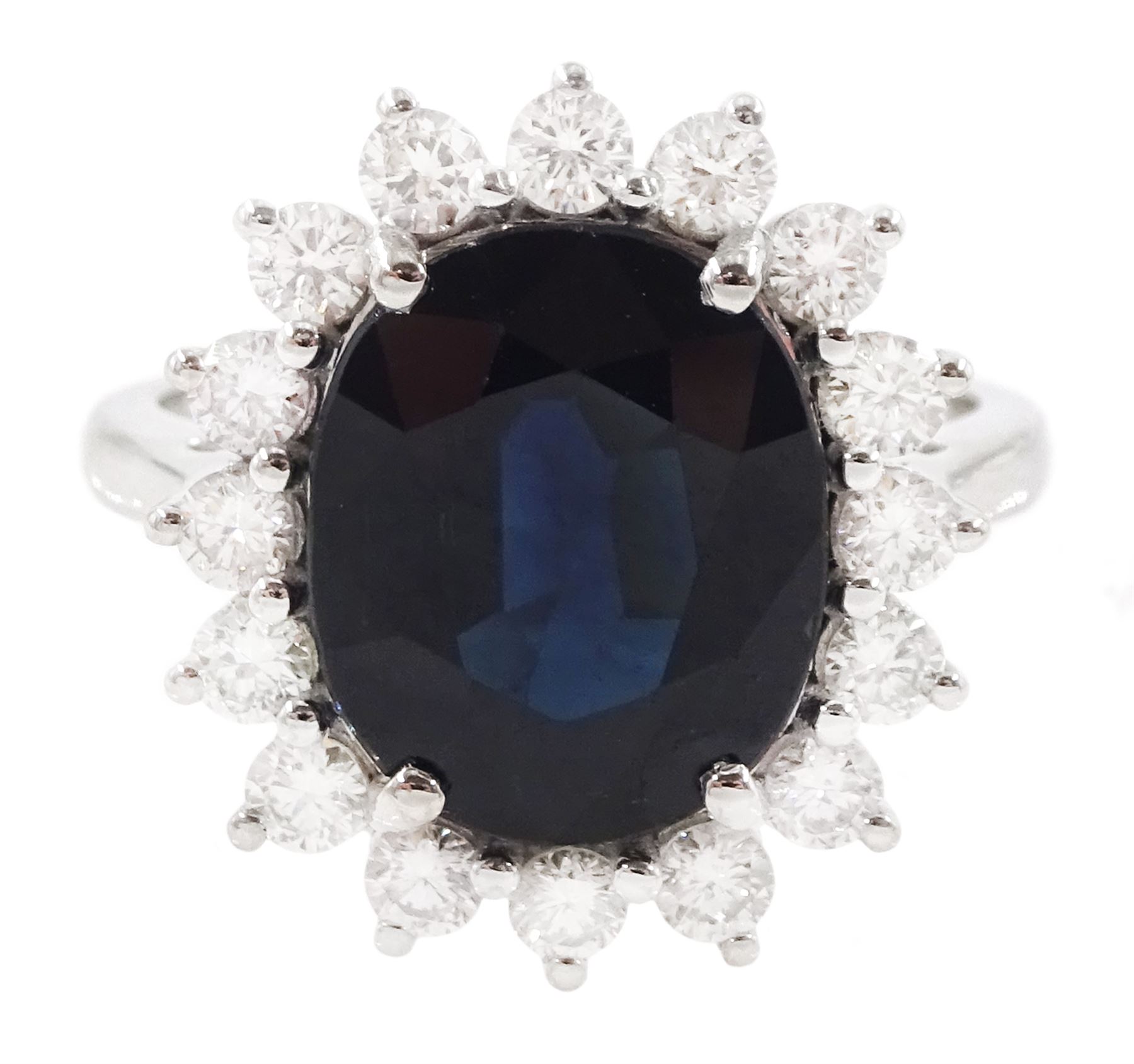 18ct white gold sapphire and diamond cluster ring, single oval cut sapphire of 4.33 carat, with round brilliant cut diamond surround, stamped 750, total diamond weight 0.72 carat