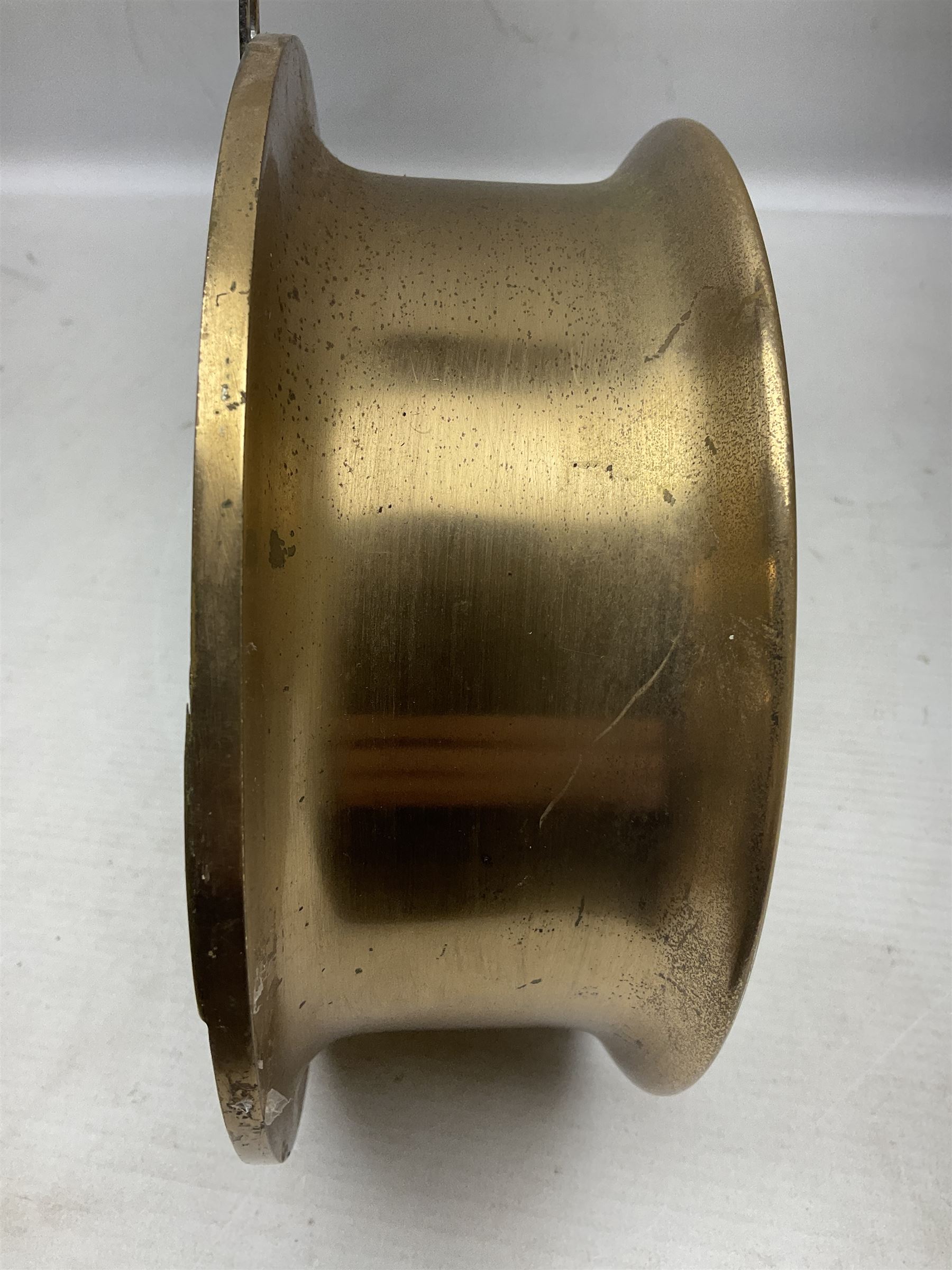 WWII period US Navy Mark I deck clock, the black circular dial with Arabic numerals,  luminous dot markers and subsidiary seconds dial marked 'Mark I Deck Clock U.S. Navy 15211 1941', in bronze bulk head case D20cm; and a Loose-Wiles Biscuit Company octagonal tin decorated with nine different US Warships (2)