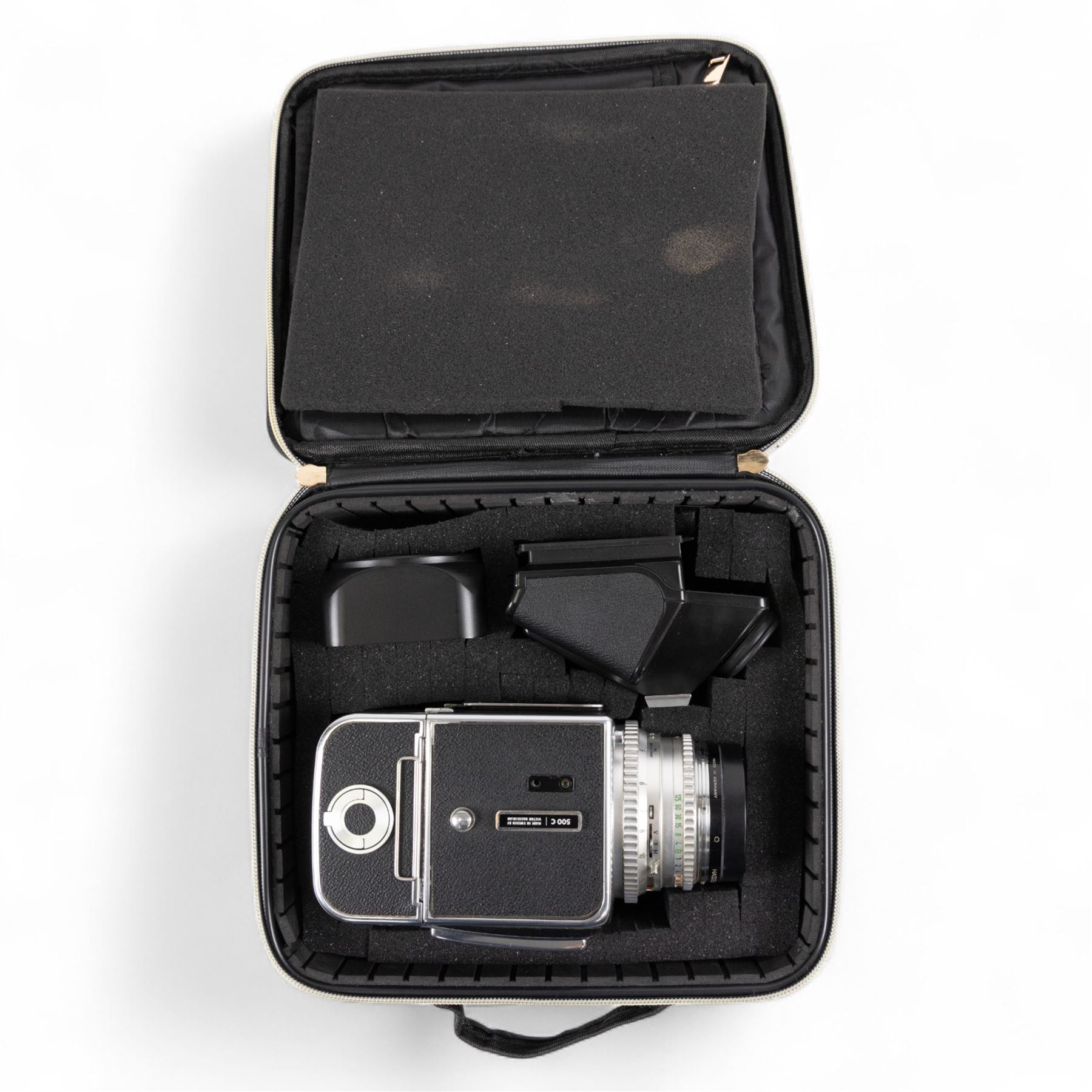 Hasselblad 500C medium format camera, serial no. TC60836, circa 1965, with Carl Zeiss Planar 1:2.8 f=80mm lens with cap, serial no. 4199654, one film back, serial no. TC87300 and a Hasselblad PM5 prism viewfinder serial no. 401EE1335