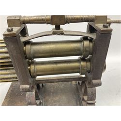 Victorian cuff and collar tabletop mangle, the ribbed brass rollers in a cast iron frame mounted on a wooden base