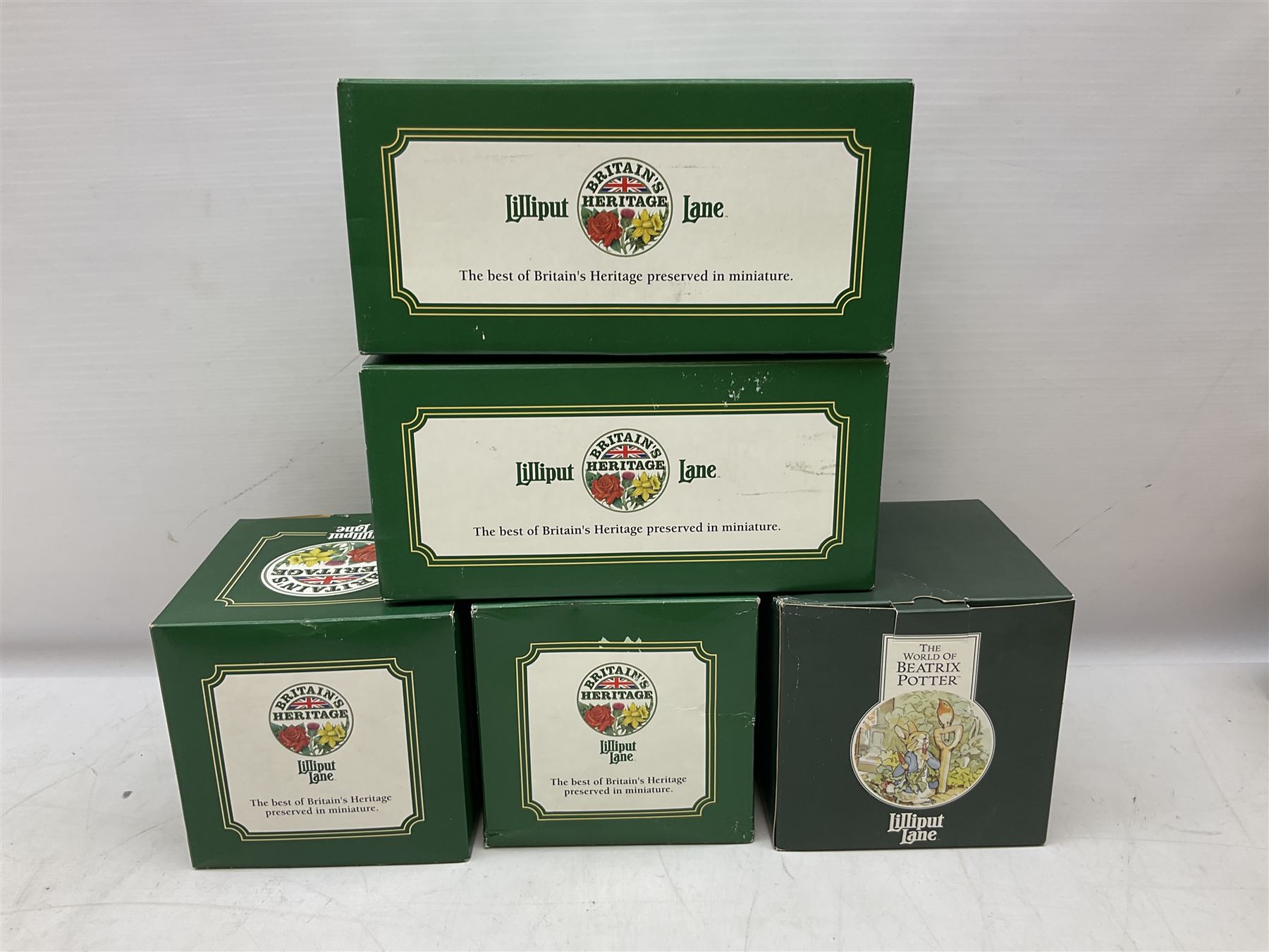 Four Lilliput Lane models from the 'Britain's Heritage' collection, comprising Edinburgh Castle, The World Famous Blacksmith's Shop Gretna Green, Shakespeare's Birthplace and Mickelgate Bar York, together with  a Lilliput Lane Beatrix Potter Hill Top model, all boxed