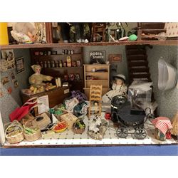 Seagull Pub - scratch-built wooden doll's house as a two-storey gable fronted public house painted in white green and maroon; the hinged front with ground floor veranda and window over opening to reveal two fully furnished rooms with dog-leg staircase and well stocked bar with bar-tender L31cm H62cm D37cm; together with Corner Shop and Dollies Pantry; a similarly painted scratch-built wooden two-storey flat-roofed doll's house as a well stocked ground floor grocery shop with stairs up to two further fully furnished rooms and more stairs giving access to a roof terrace L46cm H57cm D33cm (2)